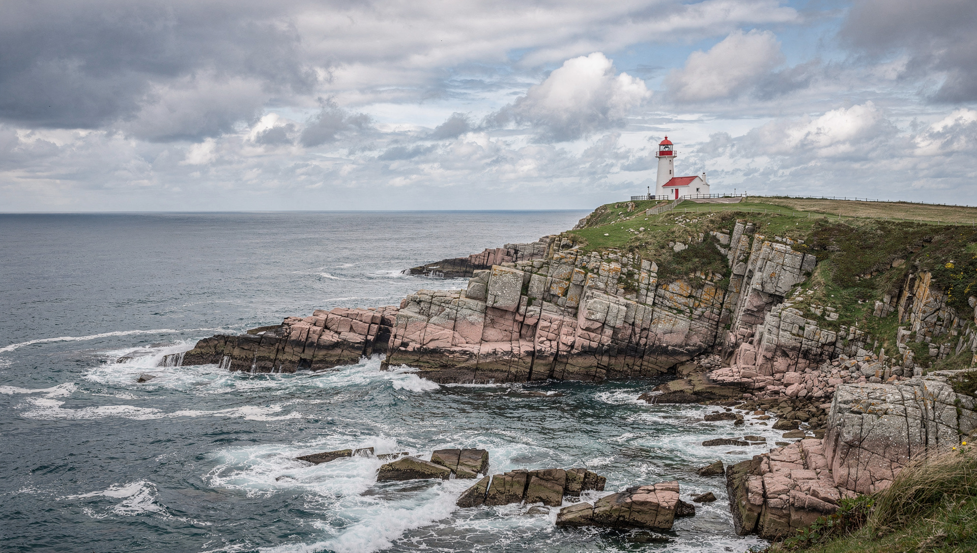 Coastal landscape of the Channel Islands with cliffs and a sweeping bay